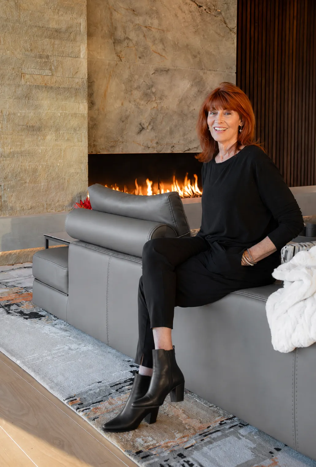Marian Rockwood by the fireplace